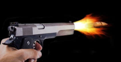 hand-holding-gun-firing-bullet-260nw-513238717.jpg