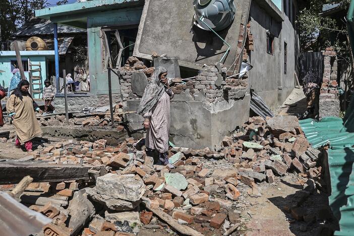 TOPSHOT - People walk through the debris of a demolished house related to the family of Ashif Sheikh, who is suspected of involvement in the Pahalgam tourist attack, in Monghama village of Tral south of Srinagar on April 25, 2025. Soldiers in Indian-administered Kashmir on April 25 blew up the family homes of two men who police allege were among a gang that carried out the region's deadliest attack against civilians for decades. (Photo by HABIB NAQASH / AFP) (Photo by HABIB NAQASH/AFP via Getty Images)
