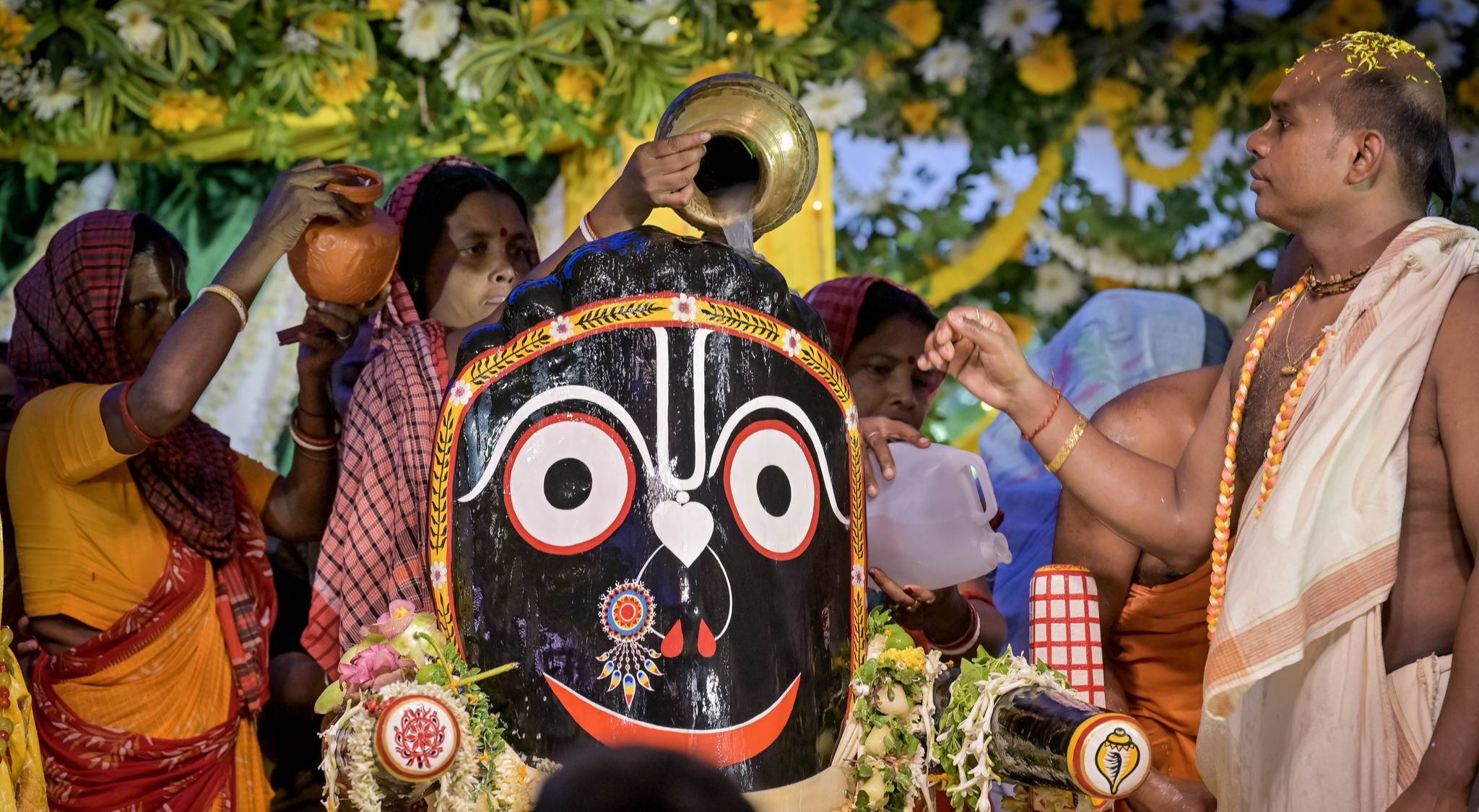Devotees-bathing-Lord-Jagannath-at-ISKCON-Rajapur