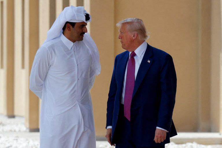 FILE PHOTO: U.S. President Donald Trump talks with Qatar's Emir Tamim bin Hamad Al Thani in Doha, Qatar, May 15, 2025. REUTERS/Brian Snyder/File Photo